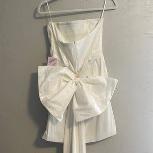 STUNNING white dress with long bow, would be the perfect dress for a bride-to-be